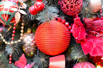 Red Christmas ball on Christmas tree. Close up