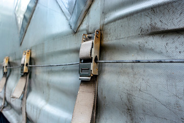 attaching the awning of the cargo trailer closeup © Mykola