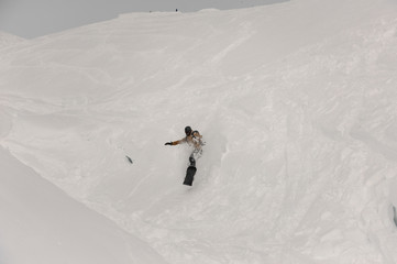 Paralympic snowboarder riding on the white snow covered hill