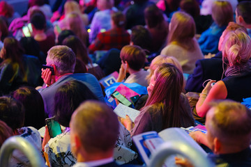 Business conference attendees sit and listen