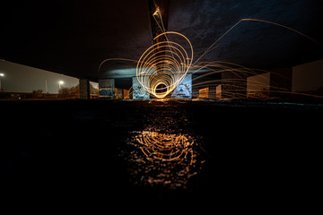 Light paint with spinning fire sparks that are jumping arround