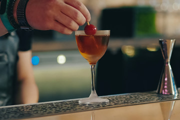 Bartender pouring cocktail at bar counter