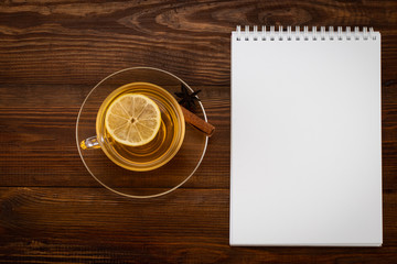 Cup of Ginger tea with lemon,on a wooden background with copy space