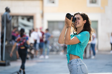 Girl tourist or professional photographer who shoots in a typical Italian city, Europa, Verona