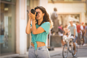 Girl tourist or professional photographer who shoots in a typical Italian city, Europa, Verona