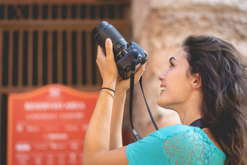 Girl tourist on vacation in Verona taking pictures, Italy, in front of the arena before the opera