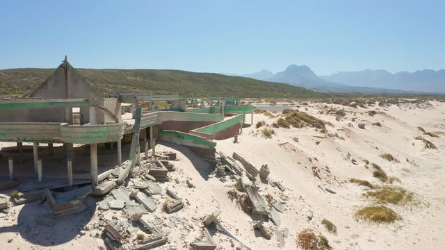 Panning Shot Showing the Macassar Pavilion Ruins with Rubles Fallen in the Sand