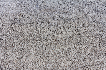Small pattern of stones and bitumen on the pavement