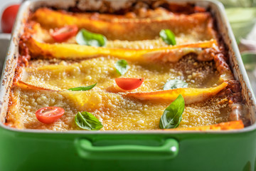 Homemade lasagna with bolognese, parmesan and basil