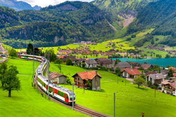 Famous electric red tourist panoramic train in swiss village Lungern, canton of Obwalden,...