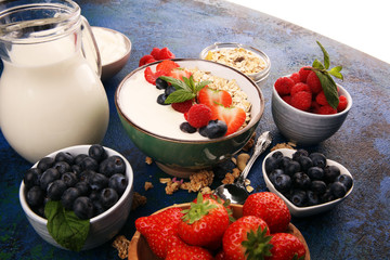 Tasty homemade granola served on table. Healthy breakfast with a bowl of oatmeal with banana, blueberries, strawberries and healthy food for Breakfast