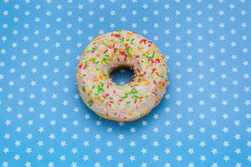 donut on blue with stars background, top view