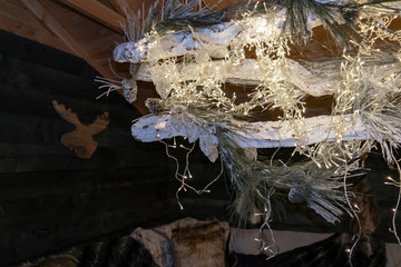 New Year and Christmas decoration of a country chalet. Christmas home in the evening with rustic decorations.