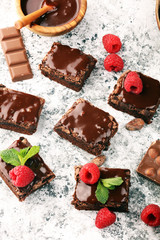 chocolate brownie cake dessert with raspberries and spices on a wooden background.