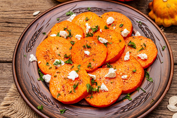 Roasted pumpkin with salted cheese and herbs