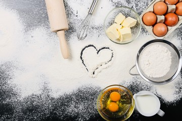 Cooking And Baking Ingredients Utensils On White Concrete Background. Kitchen Food Frame. Eggs Sugar Milk Whisker Rolling Pin And Measuring Spoons With Spices