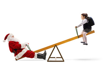 Santa Claus on a seesaw with a schoolgirl