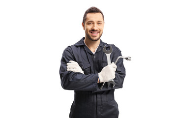 Mechanic holding car repair equipment