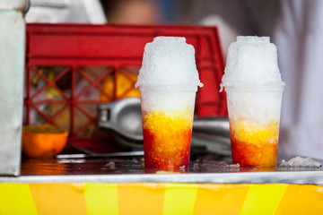 Street vendor in the city of Cali in Colombia preparing and selling a traditional sweet water ice called cholado