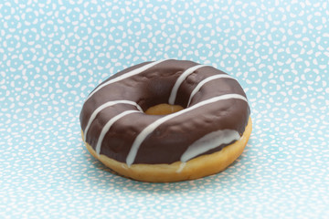 donut on blue with pattern background, close up view