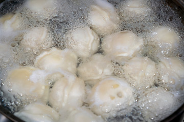 Dumplings in boiling water. Meat dumplings are boiled in a pot of boiling water.