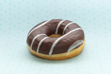donut on blue with pattern background, close up view