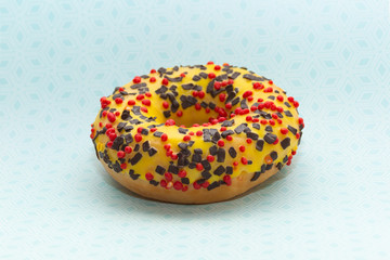 donut on blue with pattern background, close up view