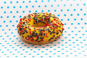 donut on white with blue stars background, close up view