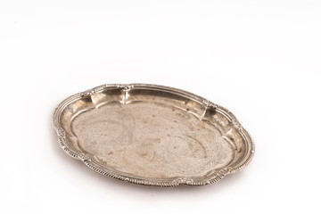 Silver vintage metal tray with stains and scratches on a white isolate.