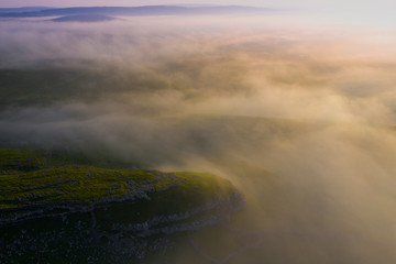 Drone shot of msty sunrise above Malham, North Yorkshire