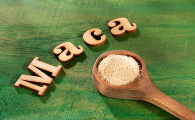 Word maca in wooden letters - Dry Organic Maca Powder. Lepidium meyenii