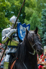 A mounted knight in shining armor readies his lance in preparation for combat in Turku, Finland. 