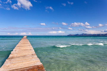 A wooden pier at Playa de Muro beach in Mallorca