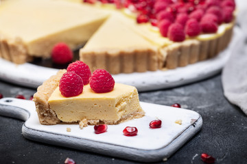 fresh french tart with raspberries on dark background