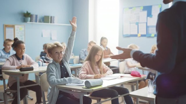 Elementary Classroom of Diverse Bright Children Listening to the Teacher Giving a Lesson. Boy Raises Hand Knowing the Right Answer. Brilliant Young Kids in School Learning Science, Creative Thinking