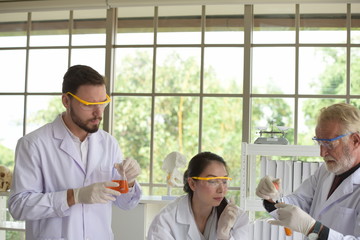 Scientists are working in science labs.Close-up of a scientistYoung female scientist looking through a microscope in a laboratory doing research