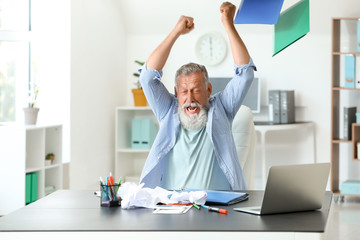 Angry mature man working in office