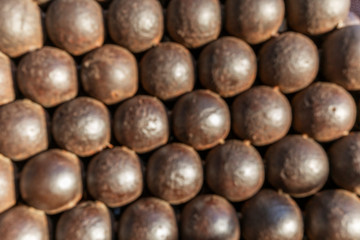 Mountain of cannonballs. Blurred. Background. Space for text.