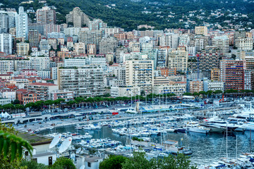 Fototapeta premium Monte Carlo, Monaco, 10/05/2019: A beautiful top view of the city marina with luxori yachts and the architecture of a rich city.