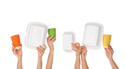 Obraz na płótnie Canvas Many hands with food containers and cups on white background