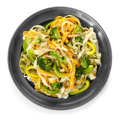 Plate with tasty pasta and vegetables on white background