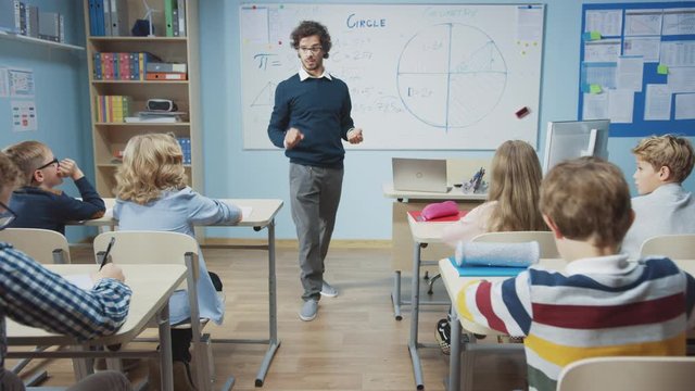 Zoom In Portrait of Teacher Explaining Lesson to a Classroom Full of Diverse Bright Children, In Elementary School Group of Smart Multiethnic Kids Learning Science and Creative Thinking. Moving Camera