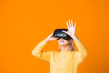 Computer game player uses virtual reality. A young woman in a virtual reality helmet