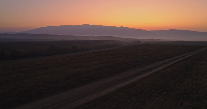 Aerial drone fly over northern Hungarian landscape at sunrise. Northern Matra mountains and hills.