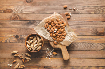 Tasty almonds on wooden background
