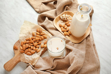 Tasty almond milk on white background