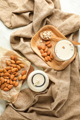 Fototapeta na wymiar Tasty almond milk on white background