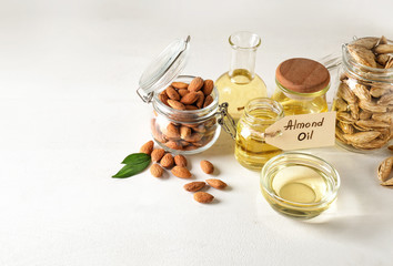 Tasty almond oil on white background