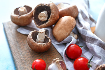 Obraz na płótnie Canvas Fresh champignon mushrooms and tomatoes on table