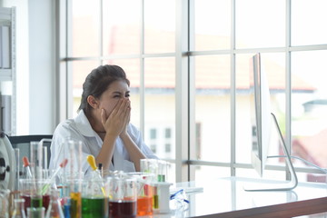 Young women scientists are experimenting with science at the lab.Asian scientist holding a test tube in a laboratory	